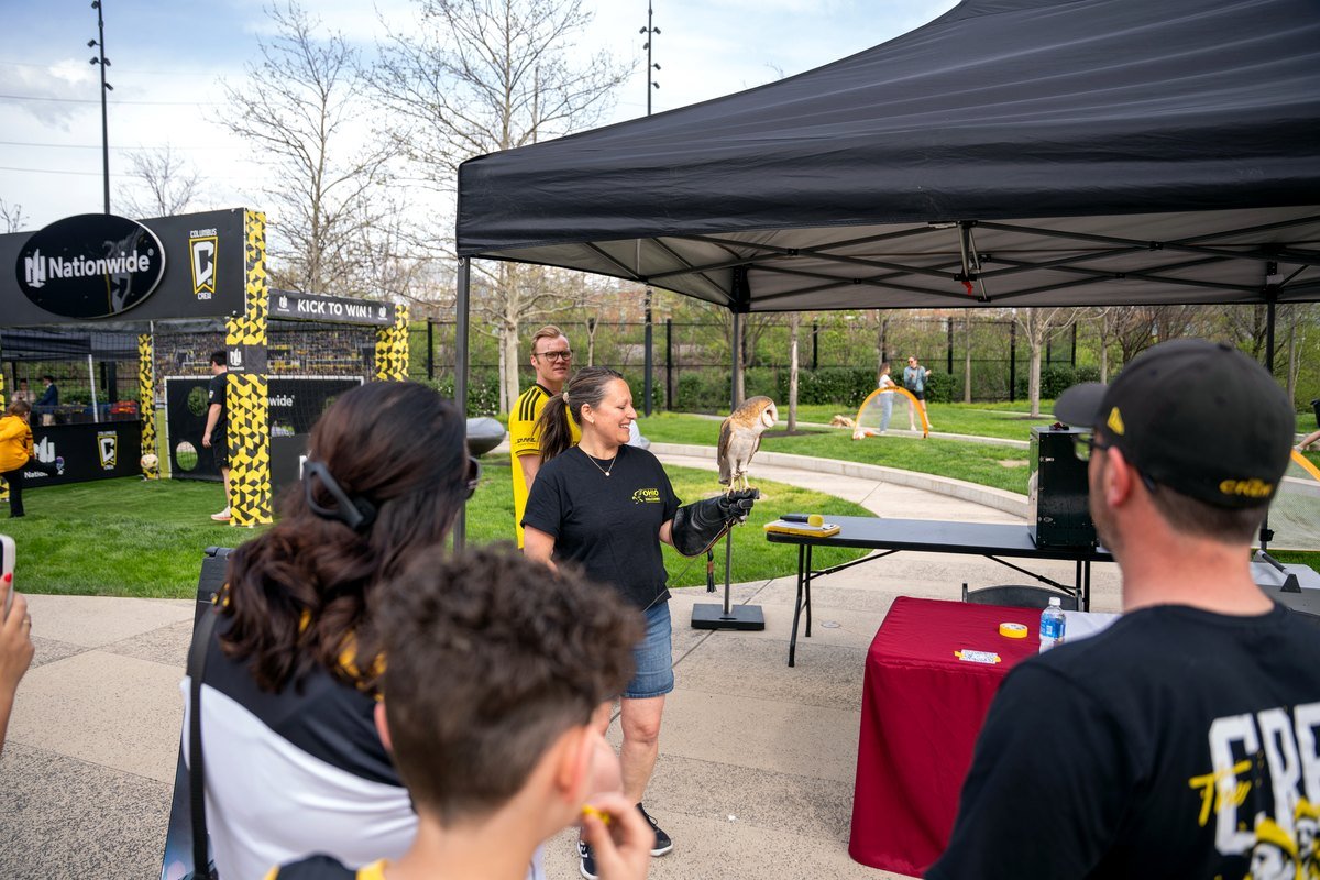Ohio School of Falconry educator speaking with Columbus Crew guests